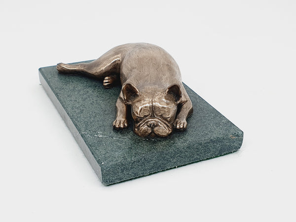 A sculpture of a French Bulldog sleeping on a Lakeland sate base