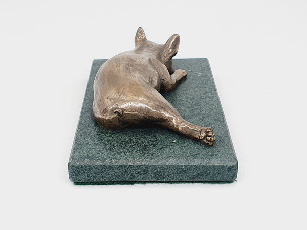 A sculpture of a French Bulldog sleeping on a Lakeland sate base