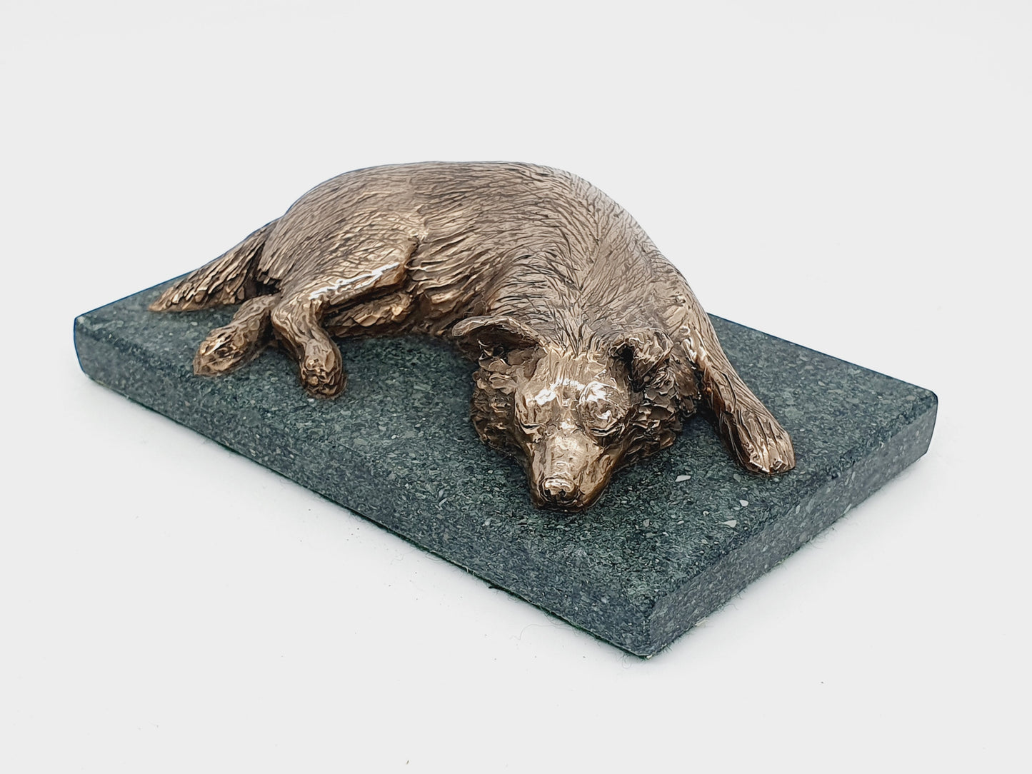 Bronze dog sculpture of a Border Collie sleeping