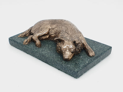 Bronze dog sculpture of a Border Collie sleeping