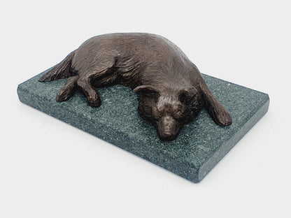 A bronze sculpture of a Border Collie on a Lakeland slate base
