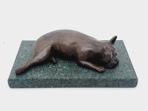 A sculpture of a French Bulldog sleeping on a Lakeland sate base